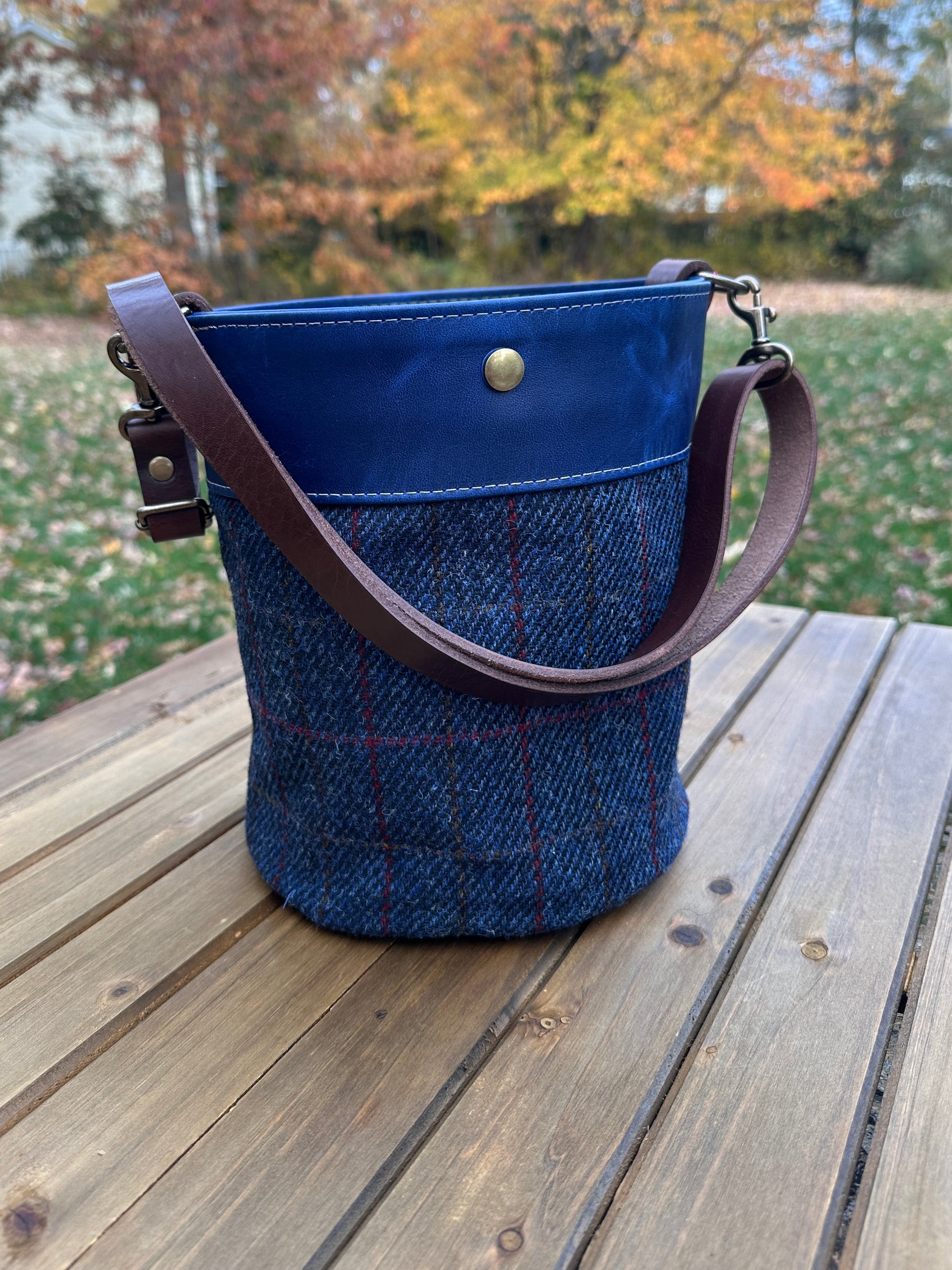 Dark Navy Harris Tweed® Lighthouse Crossbody round bag with flat bottom and Cobalt Blue Leather Accents