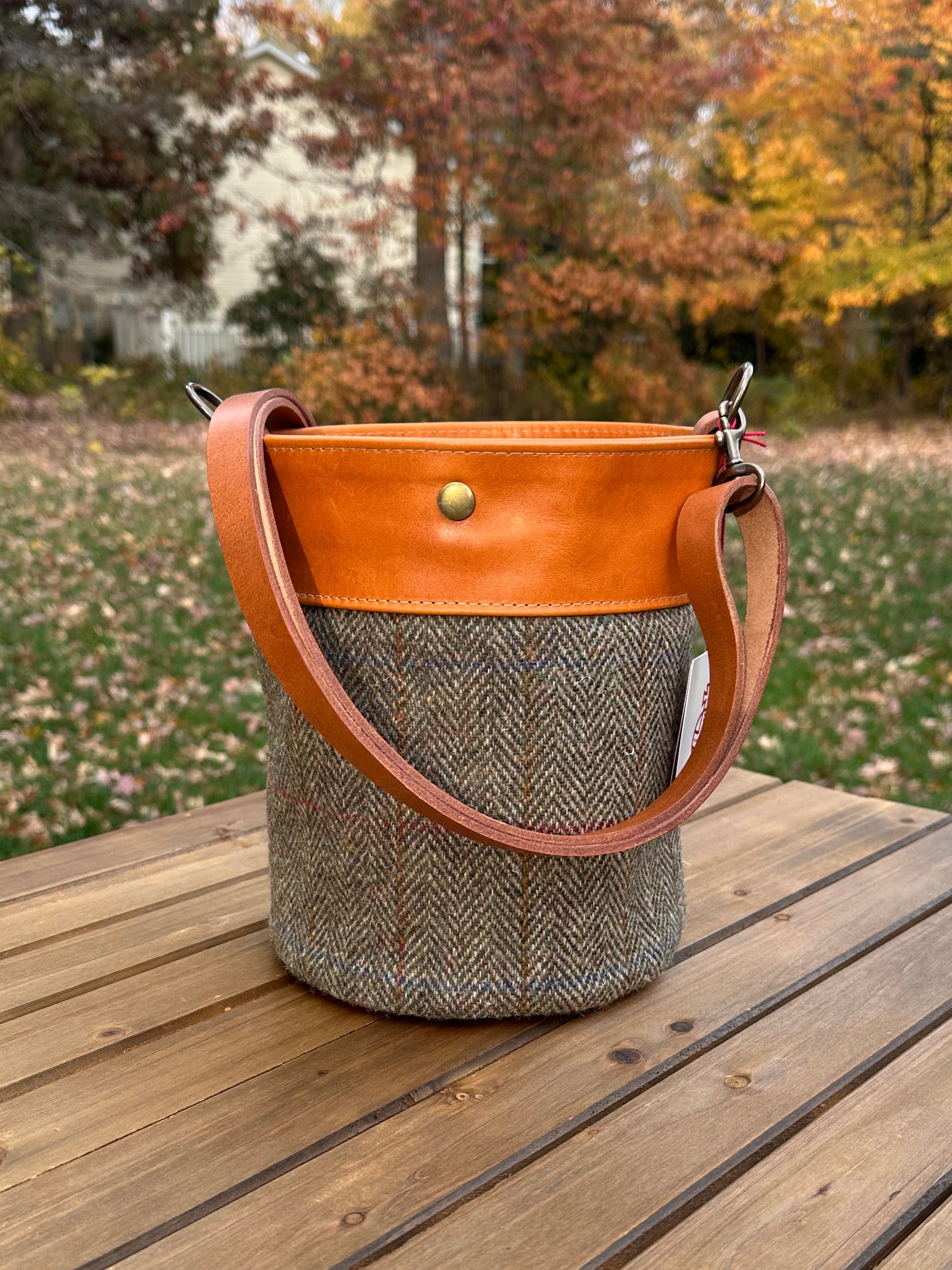 Green HerringboneHarris Tweed® Lighthouse Crossbody round bag with flat bottom and Acorn Leather Accents