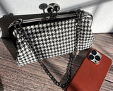 Handcrafted Harris Tweed® kiss lock purse in Black and White Houndstooth with gunmetal hardware. Classic and elegant, made in Maryland.