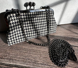 Handcrafted Harris Tweed® kiss lock purse in Black and White Houndstooth with gunmetal hardware. Classic and elegant, made in Maryland.
