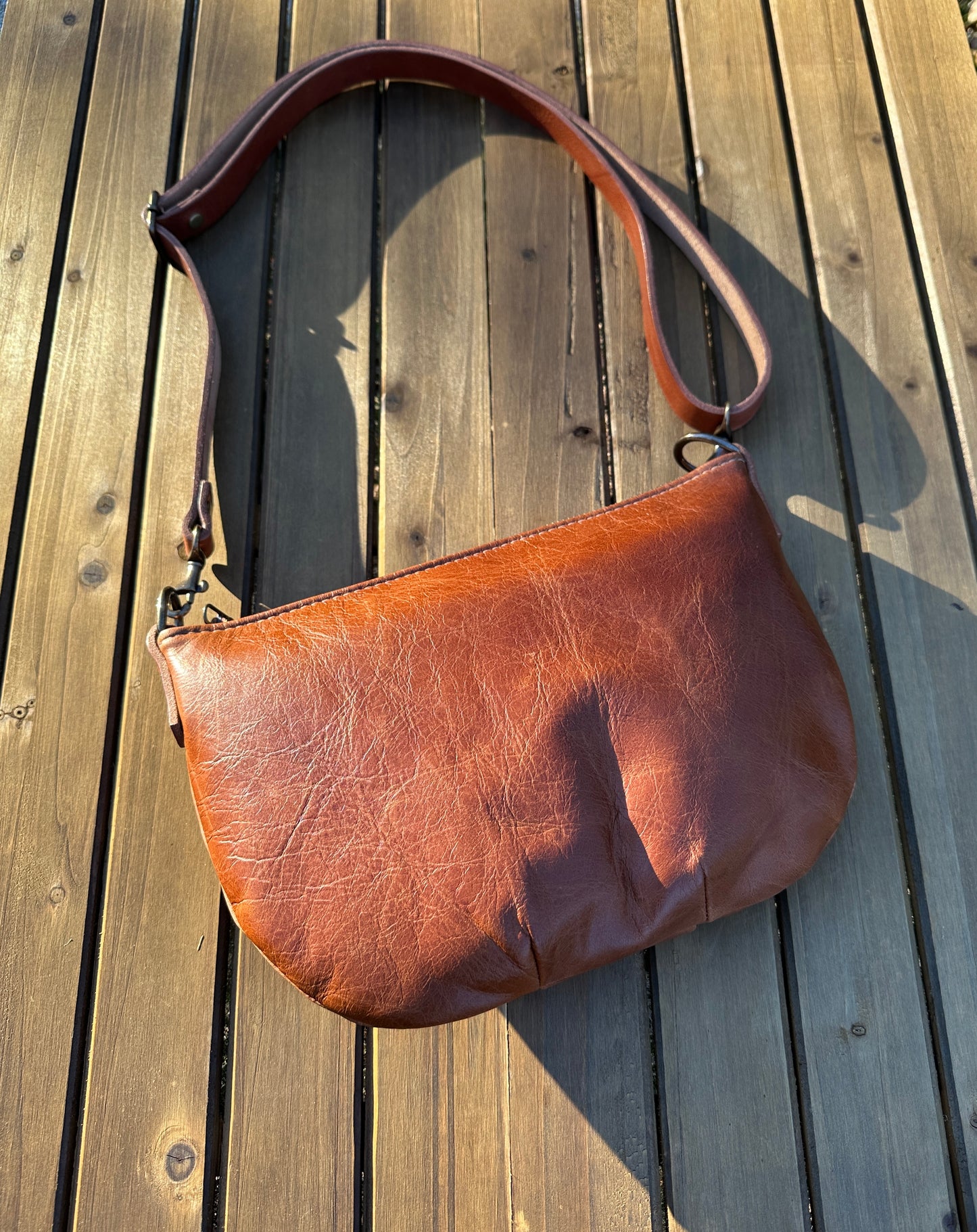 Sienna Leather Holland Island Crossbody bag with antique brass hardware and adjustable strap. 