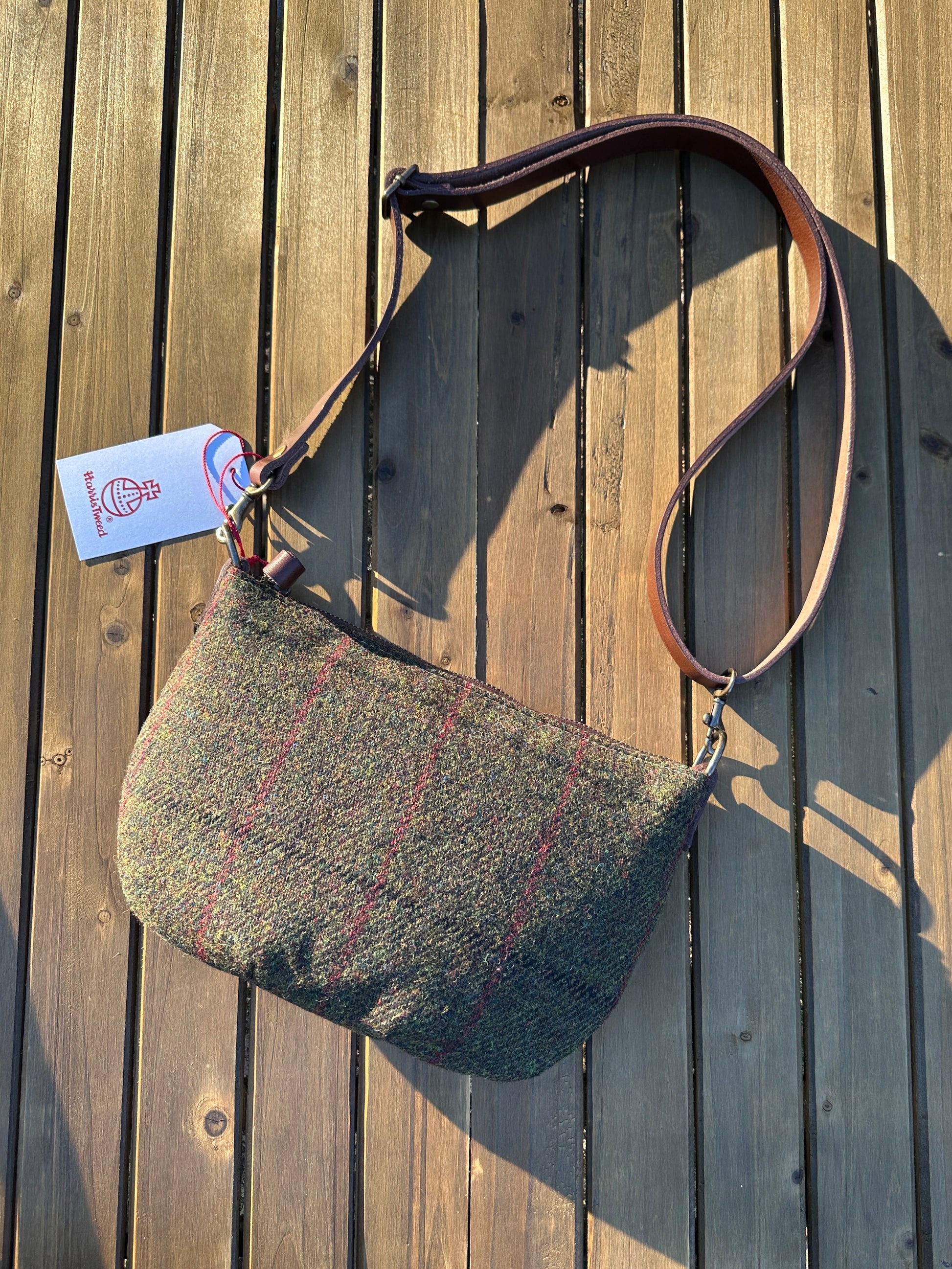 Green Twill with overcheck Harris Tweed® with adjustable strap and antique brass hardware.