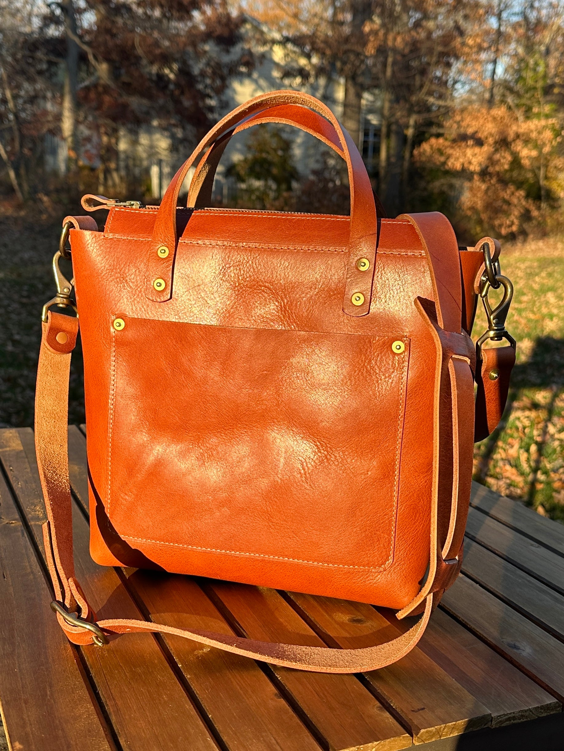 Cherry leather West Street Crossbody tote with clean minimalist front design.