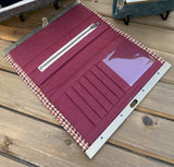 Close up view of the City Dock Wallet Fawn Burgundy and Amber Harris Tweed® Antique Brass Hardware showing the Burgundy interior. 