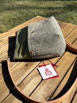 Side view of the Barra Crossbody bag showcasing top-mounted D-ring connectors and a natural tan leather strap. Designed for superior hang and durability, this hybrid canvas and tweed bag is an all-weather essential.