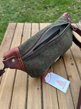 Minimalist sling bag handcrafted with Green plaid Harris Tweed® and Horween Brown Nut Leather, finished with Antique Brass hardware.